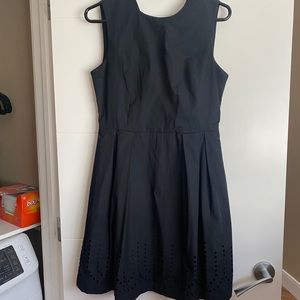black dress with cutout design at hem